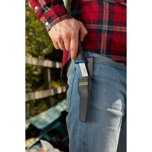 Photo of STANLEY 0-10-232 utility knife with black handle and sheath, clipped to jeans pocket outdoors.
