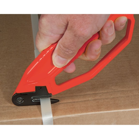 STANLEY 0-10-244 safety cutter in red, photo of tool cutting packaging strap on cardboard box.