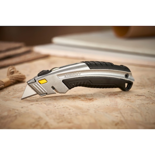 STANLEY 0-10-788 utility knife with silver and black body, angled on work surface.