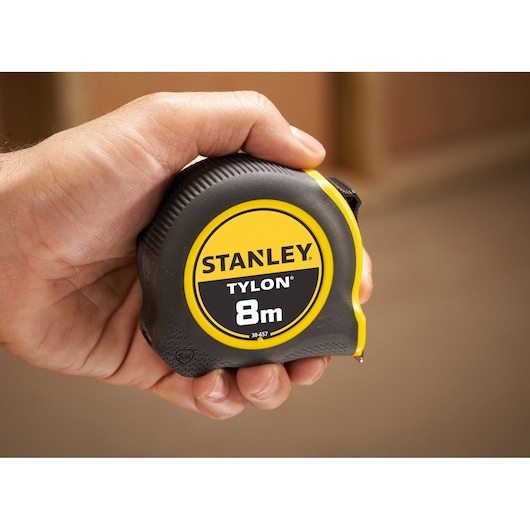 Photo of STANLEY 0-30-657 Tylon 8m tape measure in hand, black and yellow casing.