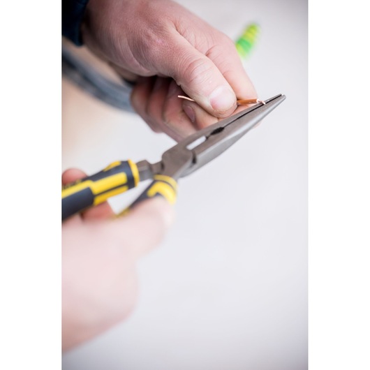 Photo of STANLEY 0-89-870 long nose pliers with yellow and black handle gripping wire, close-up.