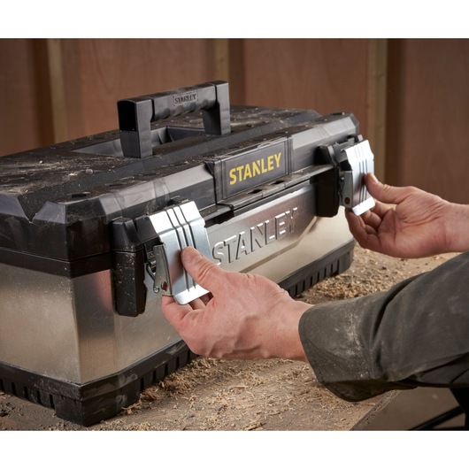 STANLEY 1-95-619 metal toolbox with black lid being opened by hands, photo from front angle.