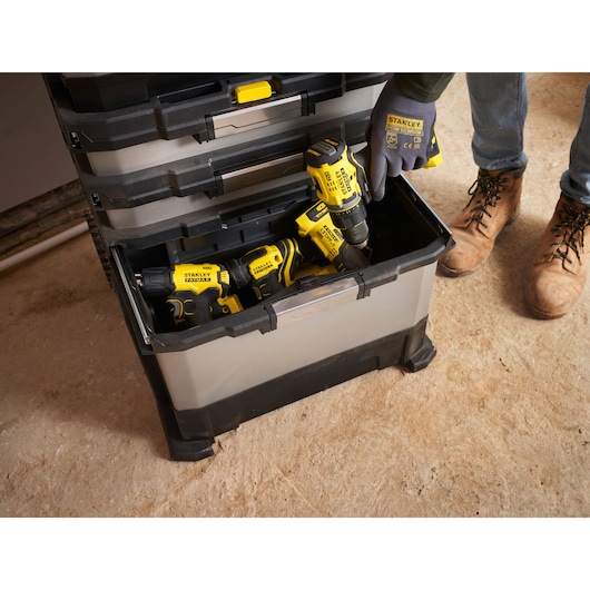 STANLEY 1-95-622 tool box with open drawer showing power tools and a person wearing STANLEY gloves.
