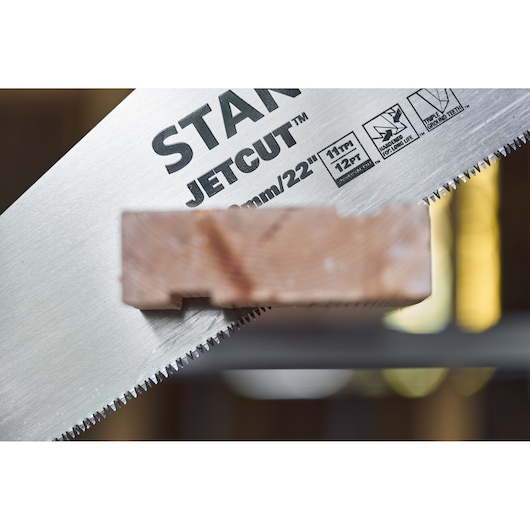 STANLEY 2-15-244 hand saw cutting wood close-up, showing JetCut teeth and product details.