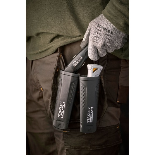 Stanley FMHT10500-0 utility knives in black holsters, worn on work trousers, close-up view.