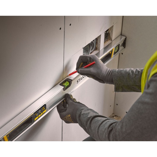 Photo of STANLEY FMHT43674-1 spirit level used to mark drywall during construction.