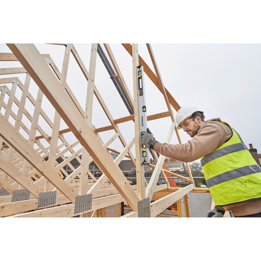 STANLEY FMHT43675-1 spirit level in use on timber frame construction site.
