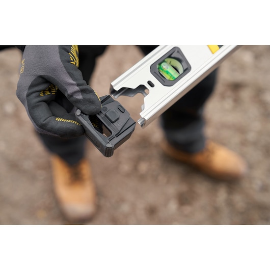 STANLEY FMHT43677 level tool photography, close-up of hand attaching black end cap.