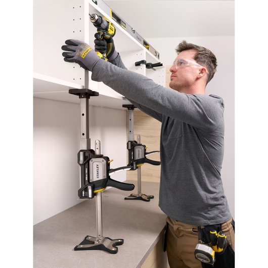 Photo of STANLEY FMHT83554-1 support clamp used to hold a cabinet in place during installation, shown from a side angle.