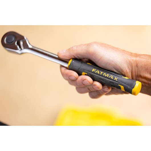 Photo of STANLEY FMMT82681-0 ratchet with black and yellow FATMAX handle held in hand, product detail view.