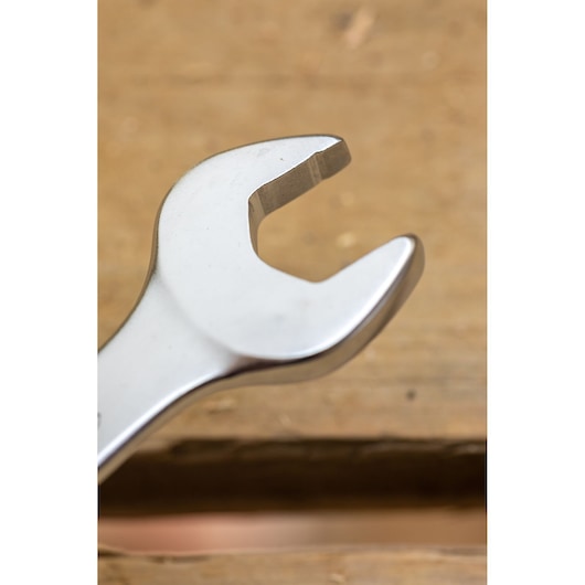 STANLEY FMMT82845-0 open-end wrench close-up, silver finish, tool on wood surface, side angle.