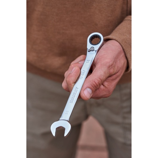 Photo of STANLEY FMMT82848-0 reversible ratcheting wrench held in hand, silver finish, 14mm size visible.