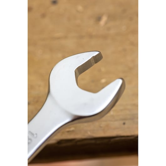 STANLEY FMMT82849-0 wrench close-up, silver open-end spanner on a wooden surface.