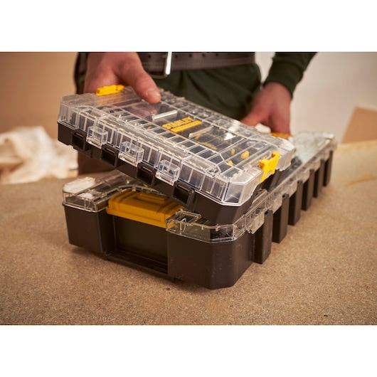 STANLEY FMMT98101-0 organizer with clear lid, yellow latch, opened on a workbench.