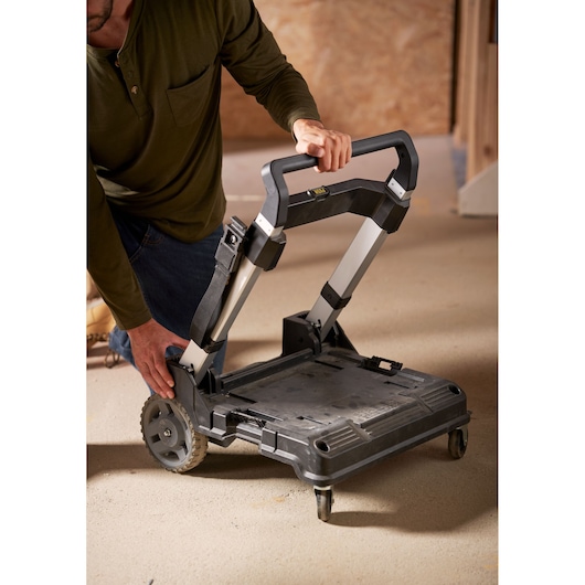 STANLEY FMST1-72363 folding hand truck with extendable handle in use on workshop floor.