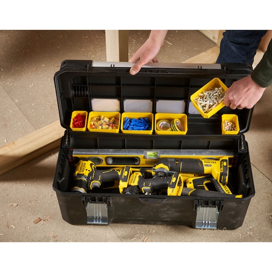 STANLEY FMST1-75791 toolbox open, showing yellow compartments with hardware and tools, top-down angle.