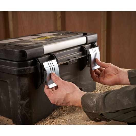 STANLEY FMST1-75792 toolbox photography, black plastic case with metal latches, handling close-up.