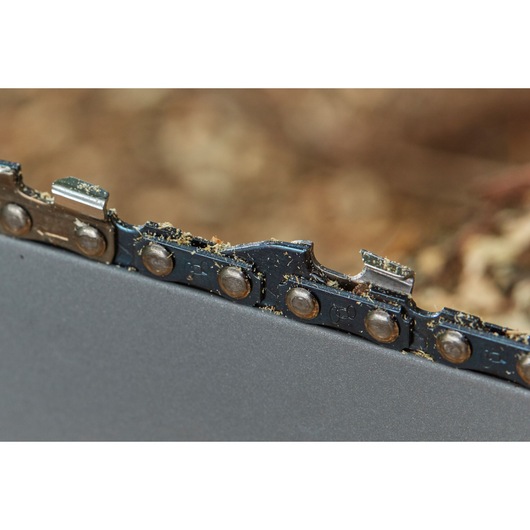 STANLEY SFMCCS630B chainsaw close-up, showing metal chain teeth and cutting edges with sawdust.