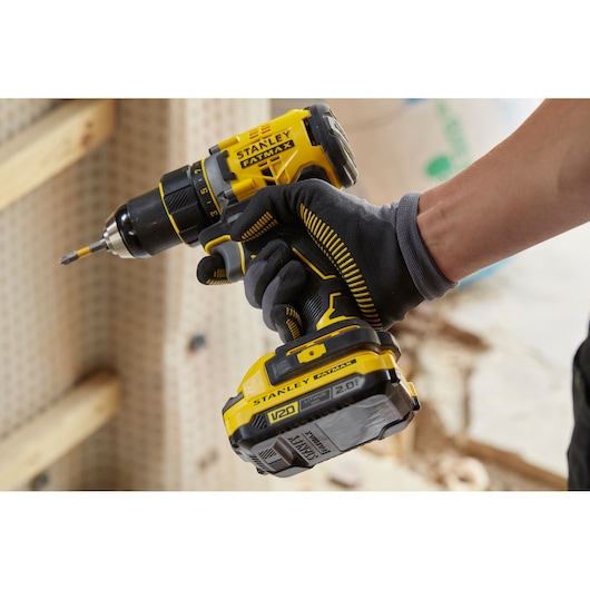 STANLEY SFMCD720B cordless drill in use, yellow and black design, close-up side angle.