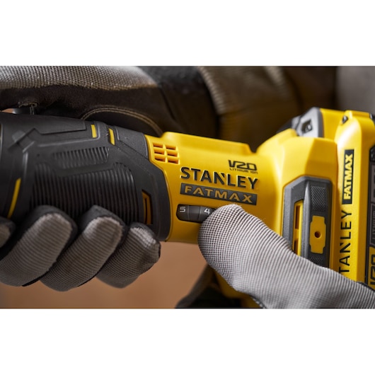 Photo of STANLEY SFMCE510B FATMAX cordless tool, close-up showing grip and speed settings.