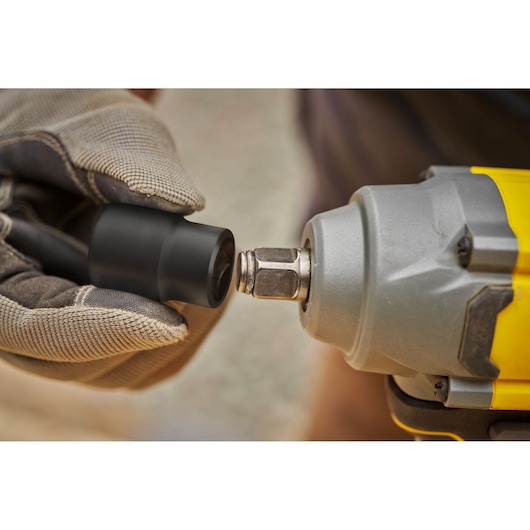 STANLEY SFMCF920B photography, close-up of impact wrench with gloved hand holding socket attachment.