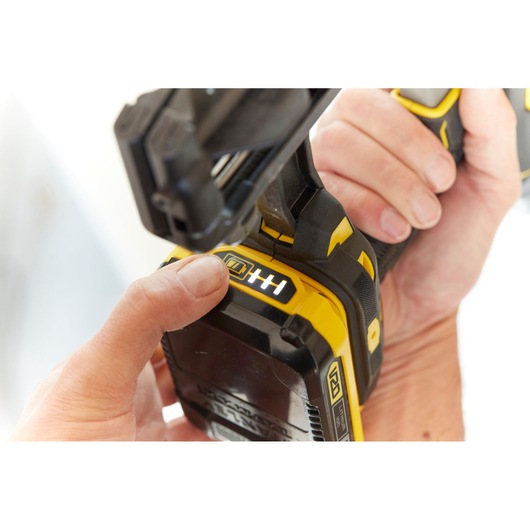 STANLEY SFMCN616B photography of yellow battery-powered tool held in hand, close-up view.