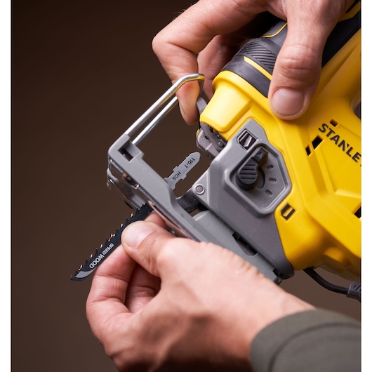 Photo of STANLEY SFMCS650M2K 18V brushless jigsaw being fitted with a blade, close-up angle.