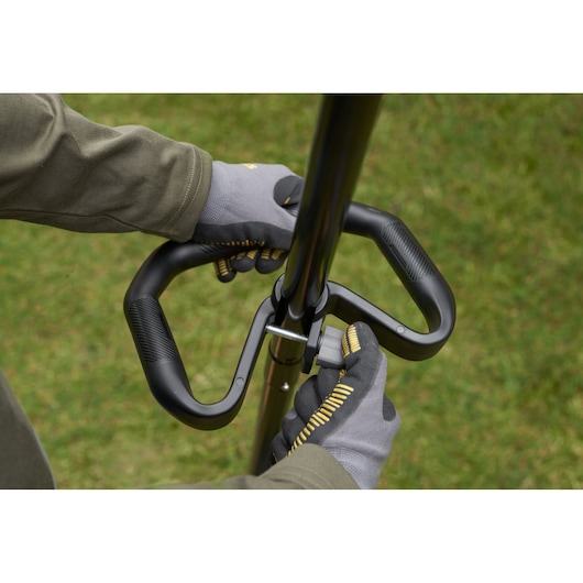 STANLEY SFMSTB930B handlebar closeup with gloved hands, outdoor use, product photography.