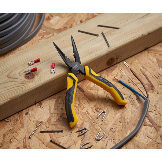 STANLEY STHT0-74363 yellow and black pliers on a wood surface with nails, connectors, and cables.