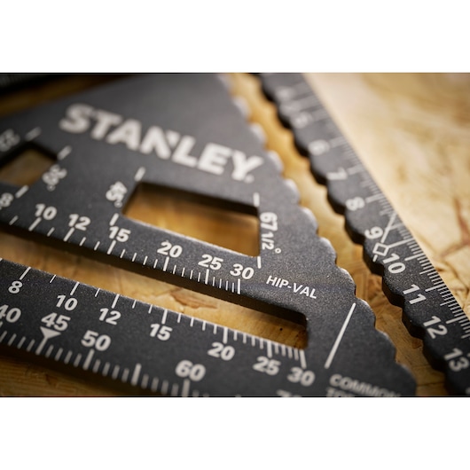 Stanley STHT46101-0 photography of black metal carpenter square with white markings, close-up angle.