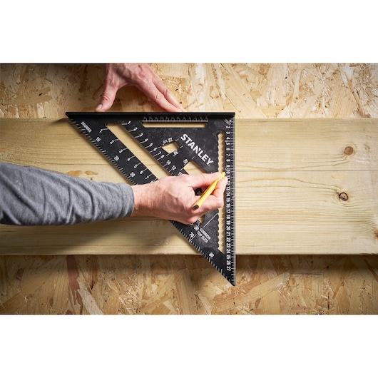 Photo of STANLEY STHT46102-0 square used to mark a wooden board during woodworking.