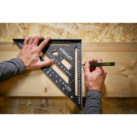 Stanley STHT46102-0 photography of black triangular carpenter’s square used for measuring on wood.
