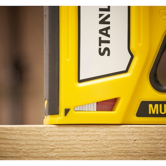 STANLEY STHT70440-0 yellow tool close-up, angled view on wood surface, photography product.