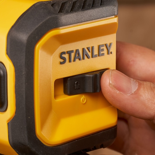 Photo of STANLEY STHT77611-0 yellow tool with black lock switch, close-up, product category: Photography.