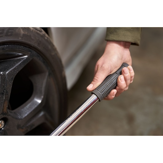 STANLEY STHT80890-0 torque wrench with textured grip, used on car wheel lug nuts, close-up photo.