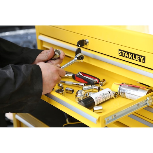 Photo of STANLEY STMT1-75062 tool drawer with ratchet, sockets, screwdriver, and lubricant canisters.