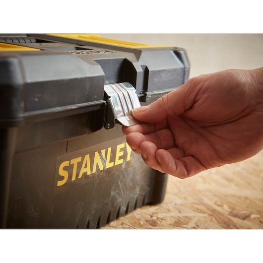 Photo of STANLEY STST1-75518-KR toolbox latch being opened, showing yellow and black toolbox front.